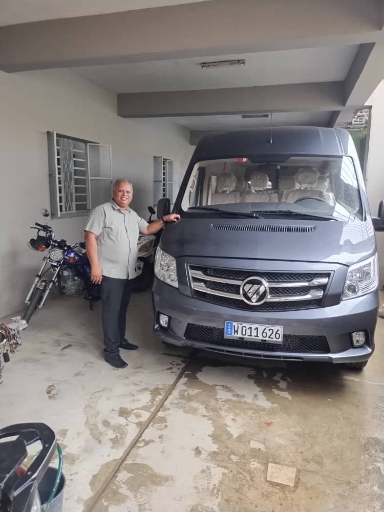 A ministry leader beside a van used to reach communities across Cuba